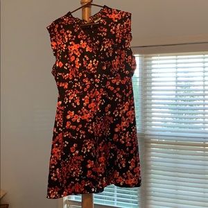 Sleeveless black dress with red flower print